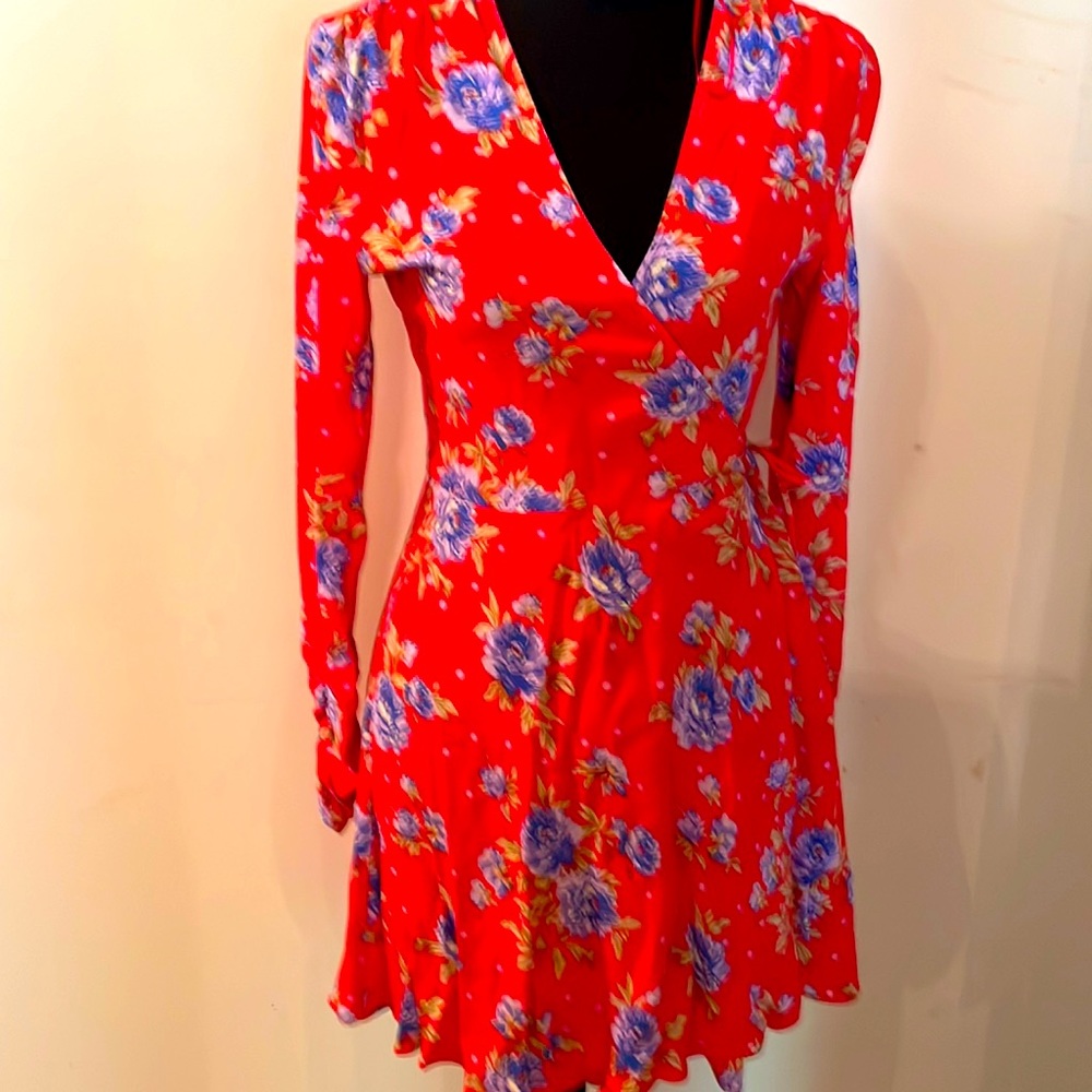 Zara wrapped dress in orange with purple flowers.